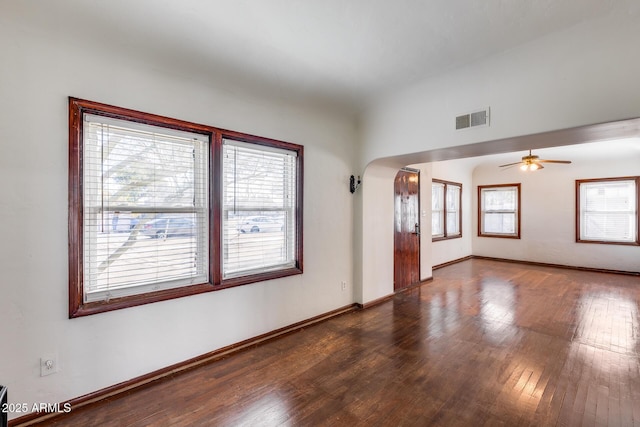 empty room featuring dark wood-type flooring and ceiling fan