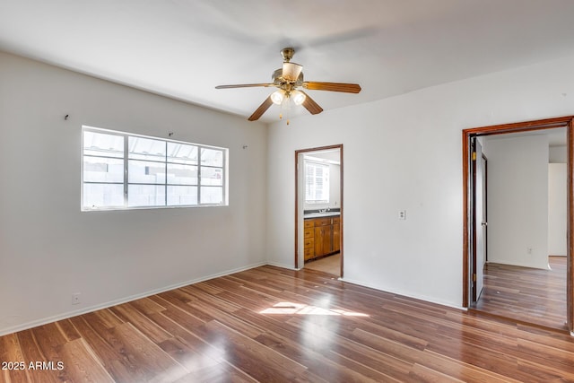 empty room featuring ceiling fan and light hardwood / wood-style flooring