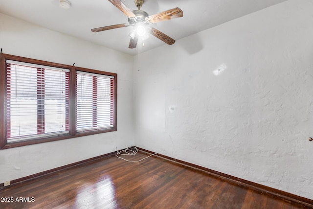 unfurnished room with ceiling fan and dark hardwood / wood-style flooring