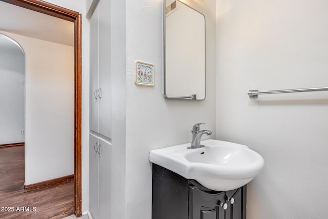 bathroom with hardwood / wood-style floors