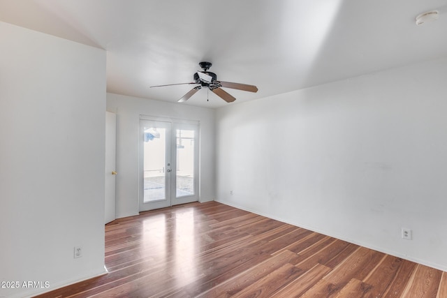 empty room featuring hardwood / wood-style flooring, ceiling fan, and french doors