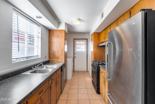 kitchen featuring appliances with stainless steel finishes, sink, and light tile patterned floors