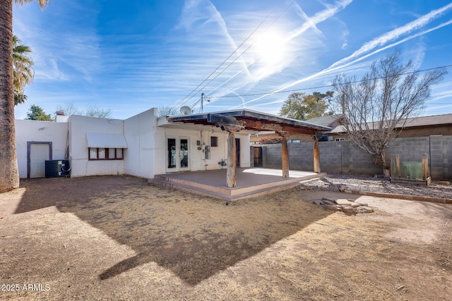 rear view of house featuring french doors, a patio, and central air condition unit