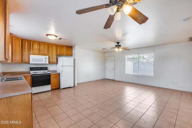 kitchen with ceiling fan, sink, light tile patterned floors, and white appliances