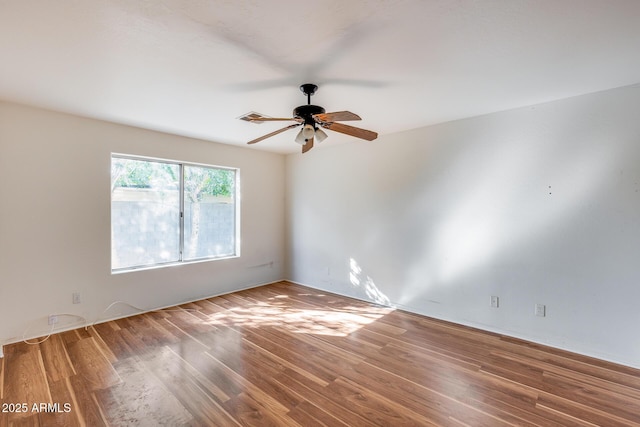 spare room with hardwood / wood-style floors and ceiling fan