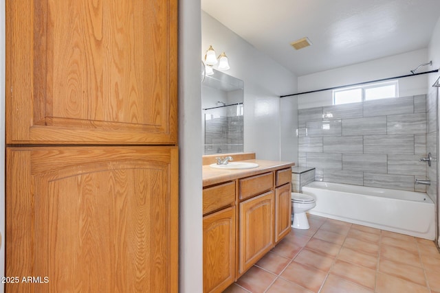 full bathroom with vanity, tile patterned flooring, tiled shower / bath combo, and toilet