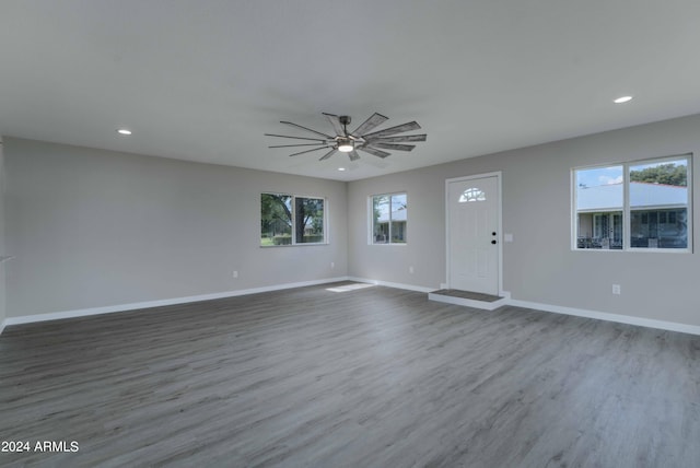 interior space featuring recessed lighting, ceiling fan, baseboards, and wood finished floors