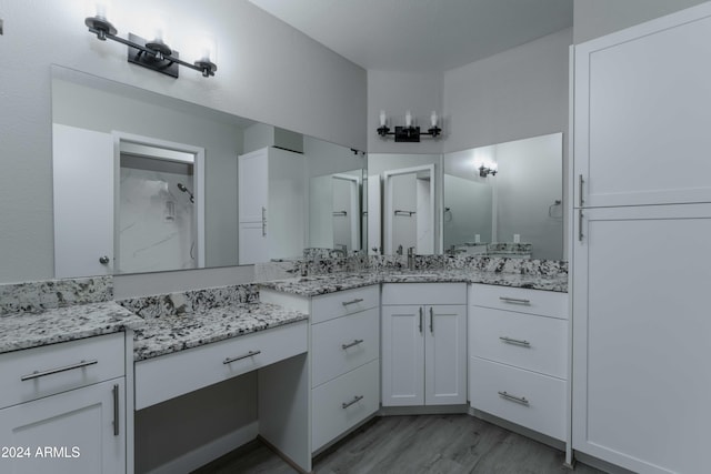 bathroom with vanity and wood finished floors