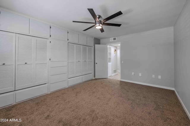 unfurnished bedroom with carpet, visible vents, ceiling fan, and baseboards