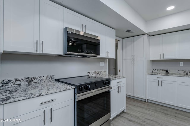 kitchen with light wood finished floors, visible vents, white cabinets, appliances with stainless steel finishes, and recessed lighting