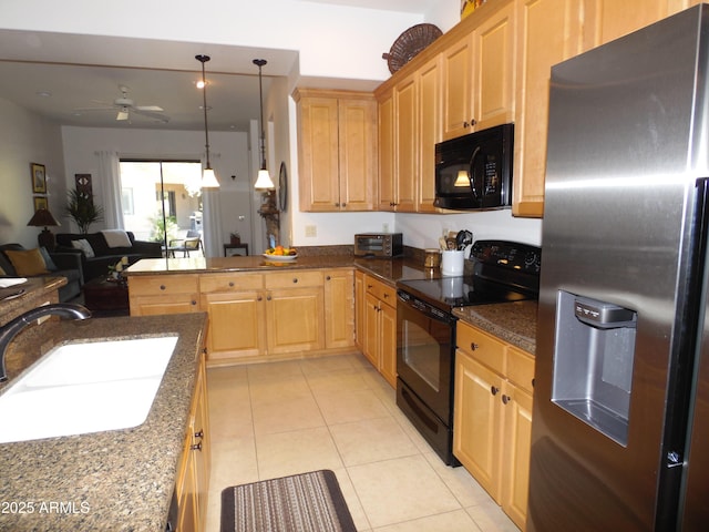 kitchen featuring black appliances, light tile patterned floors, ceiling fan, pendant lighting, and sink