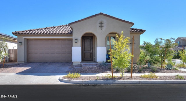 mediterranean / spanish-style home with a garage