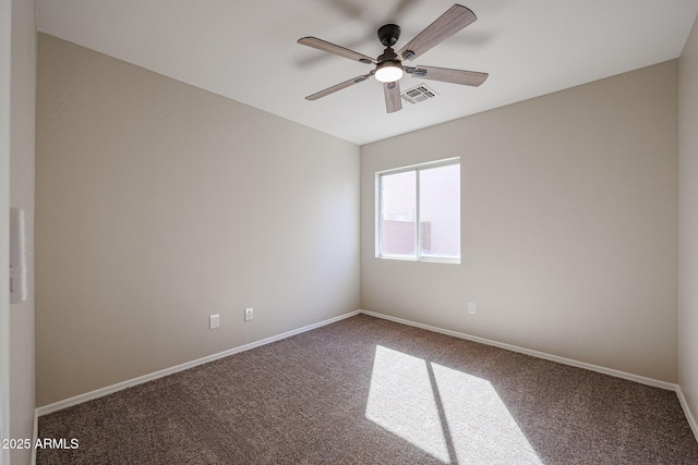 carpeted empty room featuring a ceiling fan, visible vents, and baseboards