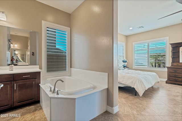 full bath with vanity, visible vents, a ceiling fan, a bath, and ensuite bath