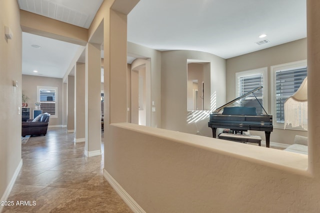 corridor featuring recessed lighting, visible vents, and baseboards