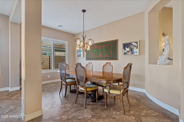 dining area featuring a chandelier, arched walkways, visible vents, and baseboards