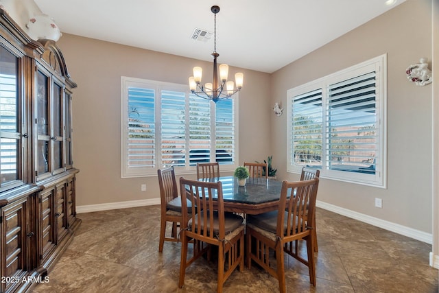 dining room featuring baseboards, visible vents, and a chandelier