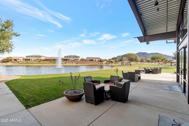 view of patio featuring a water view and an outdoor living space