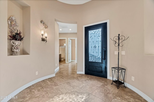 foyer with visible vents and baseboards