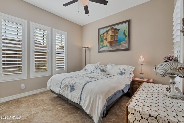 bedroom featuring ceiling fan and baseboards