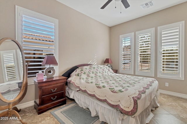 bedroom featuring light tile patterned floors, baseboards, visible vents, and ceiling fan