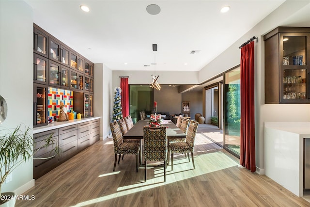 dining space with wood-type flooring