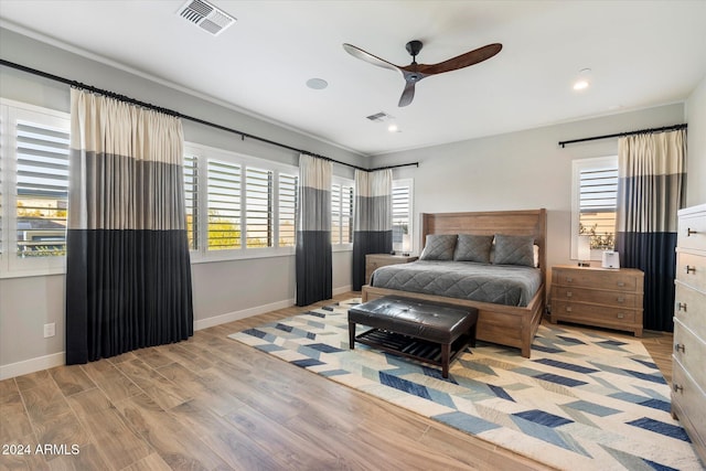 bedroom with ceiling fan and light hardwood / wood-style flooring