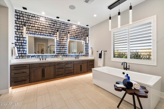 bathroom featuring vanity and shower with separate bathtub