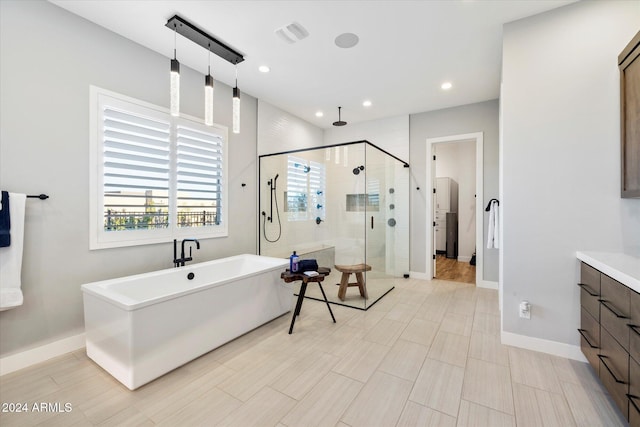 bathroom with vanity and separate shower and tub