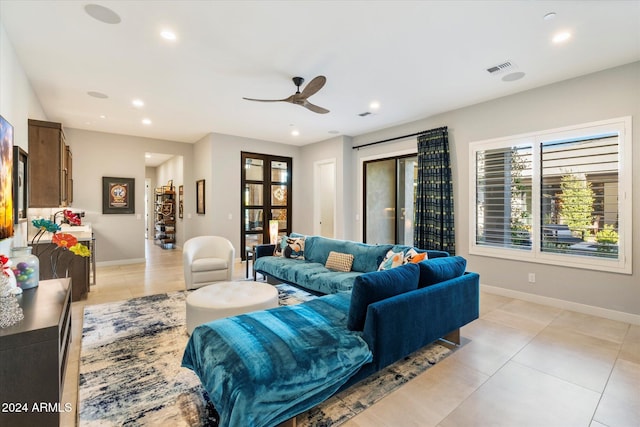 living room with ceiling fan and light tile patterned floors