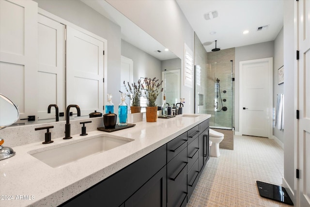 bathroom featuring vanity, toilet, and a shower with door