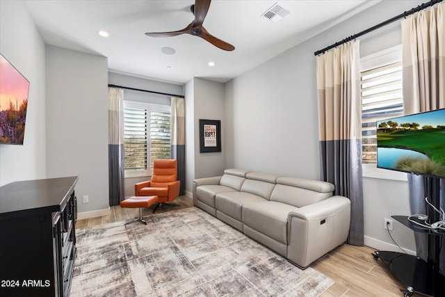 living room with ceiling fan and light wood-type flooring