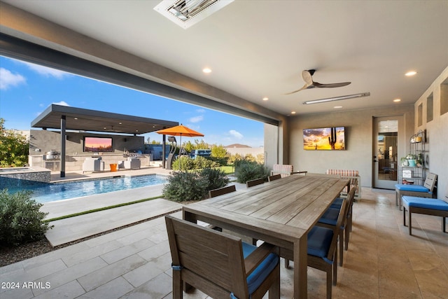 view of patio with ceiling fan and area for grilling