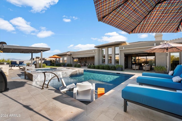 view of swimming pool with an in ground hot tub, an outdoor kitchen, an outdoor living space, and a patio