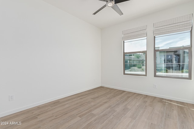 empty room with light hardwood / wood-style flooring and ceiling fan