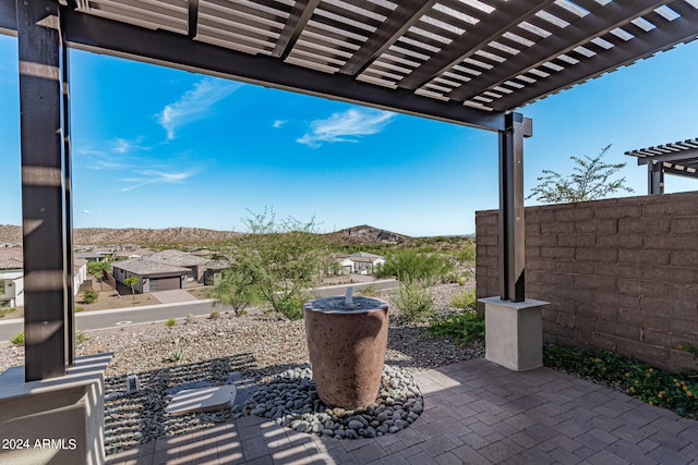 view of patio / terrace featuring a mountain view and a pergola