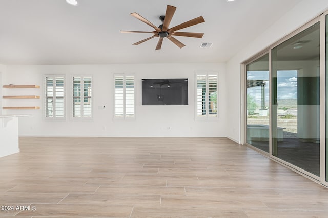 spare room with light hardwood / wood-style flooring and ceiling fan