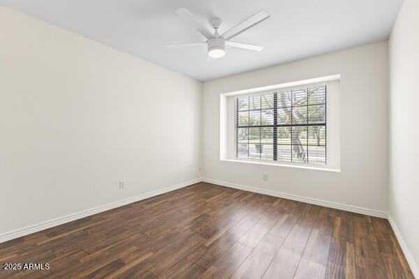5450 E Paradise Ln, Scottsdale, AZ 85254 - unfurnished room featuring dark wood-type flooring and a ceiling fan