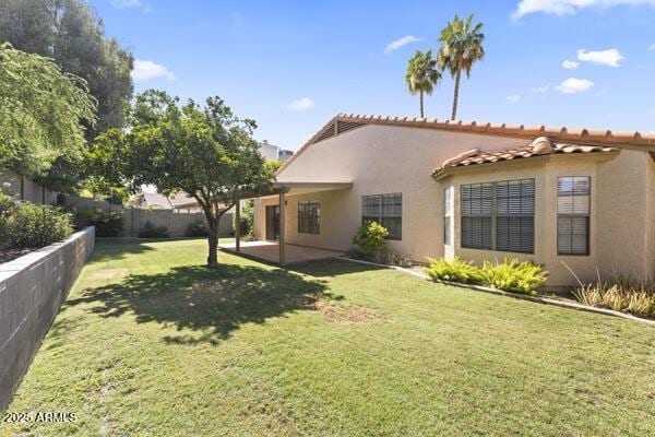 5450 E Paradise Ln, Scottsdale, AZ 85254 - back of house featuring stucco siding, a tiled roof, and a patio