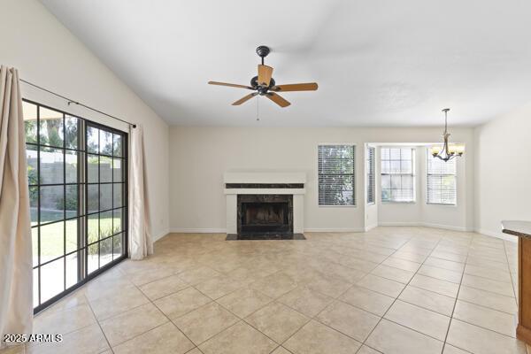 5450 E Paradise Ln, Scottsdale, AZ 85254 - unfurnished living room featuring plenty of natural light, light tile patterned floors, a chandelier, and a ceiling fan
