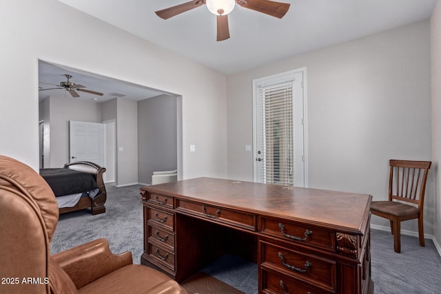 carpeted office space featuring visible vents, ceiling fan, and baseboards