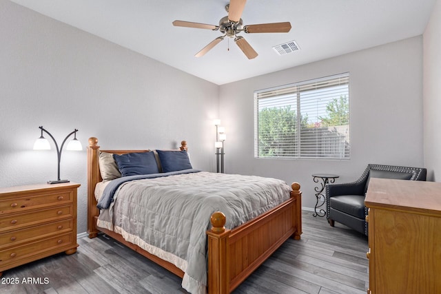 bedroom with visible vents, ceiling fan, baseboards, and wood finished floors