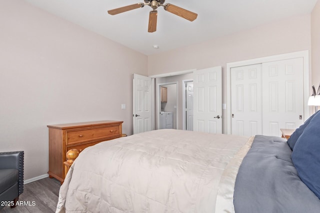 bedroom with a closet, a ceiling fan, wood finished floors, washer and dryer, and baseboards