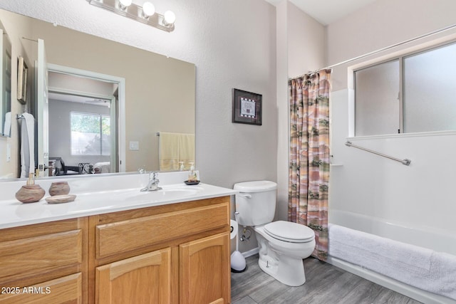 bathroom with wood finished floors, shower / bath combo, vanity, and toilet