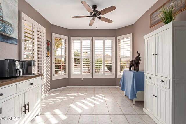 interior space with plenty of natural light, ceiling fan, and light tile patterned flooring