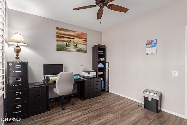 home office with ceiling fan and dark wood-type flooring