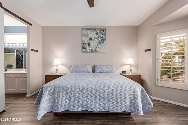 bedroom featuring ensuite bath, ceiling fan, and hardwood / wood-style floors