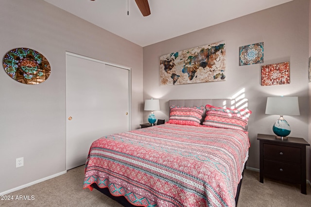 carpeted bedroom with ceiling fan and a closet