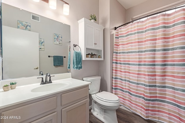 bathroom with hardwood / wood-style floors, vanity, and toilet