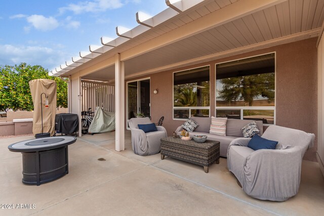 view of patio featuring an outdoor living space with a fire pit